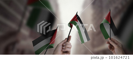 A group of people holding small flags of the Palestine in their hands 101624721