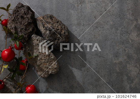 Flat lay some pomegranates and gray stones on the left. Blank space on the right for text or product Flat lay some pomegranates and gray stones on the left. Blank space on the right for text or product 101624746