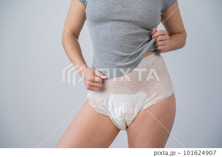 Woman in adult diapers and gray t-shirt on a - Stock Photo [101624907] -  PIXTA