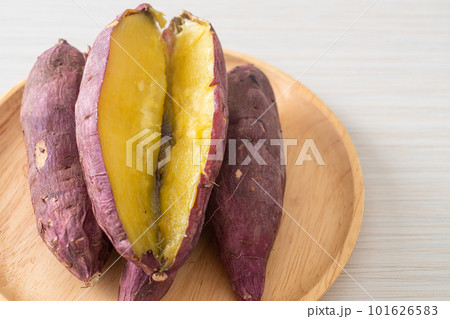 Grilled or baked Japanese sweet potatoes on wood plate Grilled or baked Japanese sweet potatoes on wood plate 101626583