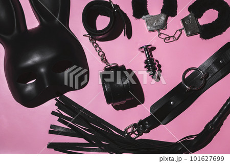 set of adult erotic toys for BDSM sex with submission and domination. Leather flogger whip, handcuffs, mask set of adult erotic toys for BDSM sex with submission and domination. Leather flogger whip, handcuffs, mask 101627699