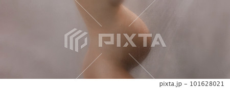 Pregnant woman belly closeup in shower. Beautiful naked out of focus blurred preagnancy body during pregnancy 3rd trimester. Maternity photo steam bath shower. Expectant woman panoramic banner 101628021