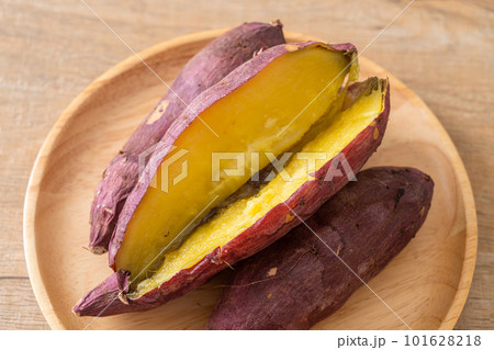 Grilled or baked Japanese sweet potatoes on wood plate Grilled or baked Japanese sweet potatoes on wood plate 101628218