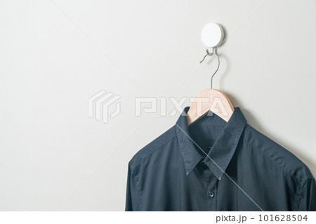 hanging shirt with wood hanger on wall 101628504
