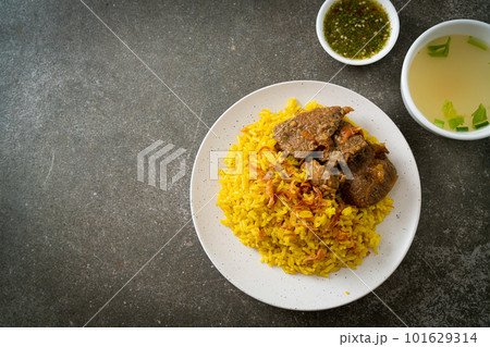 Beef Biryani or Curried rice and beef - Thai-Muslim version of Indian biryani, with fragrant yellow rice and beef Beef Biryani or Curried rice and beef - Thai-Muslim version of Indian biryani, with fragrant yellow rice and beef 101629314