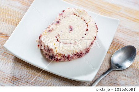 Cheese with cranberries and pasteurized milk on plate 101630091