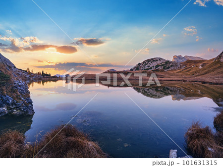 Early morning autumn alpine Dolomites mountain scene. Peaceful Valparola Path and Lake view, Belluno, Italy. Early morning autumn alpine Dolomites mountain scene. Peaceful Valparola Path and Lake view, Belluno, Italy. 101631315