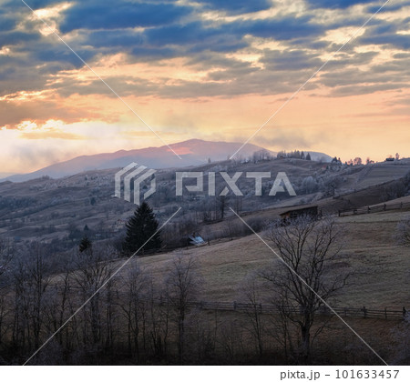 Winter coming. Last good weather days in autumn mountains countryside morning peaceful picturesque scene. Dirty road from hills to the village. Winter coming. Last good weather days in autumn mountains countryside morning peaceful picturesque scene. Dirty road from hills to the village. 101633457