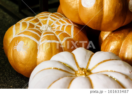 beautiful painted pumpkins of white and gold color on halloween 101633487