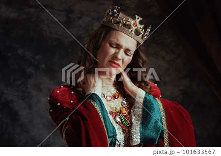 stressed medieval queen in red dress having neck pain 101633567