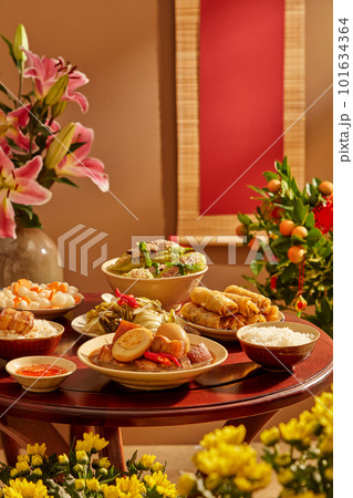 A wooden table full of Vietnamese traditional dishes commonly encountered on Tet holiday. Front view 101634364