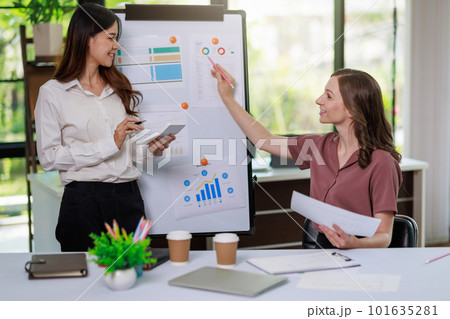 Concept of business office woman working,Businesswoman smile while working about her invesment plan with analyzing document and business investment graph data by using laptop on desk in workstation. Concept of business office woman working,Businesswoman smile while working about her invesment plan with analyzing document and business investment graph data by using laptop on desk in workstation. 101635281