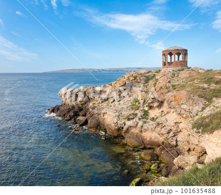 Rocky summer coastline and cape with pavilion 101635488