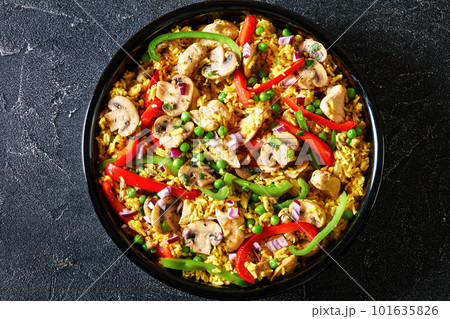 chicken mushroom paella with pepper, green peas 101635826