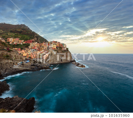 Beautiful summer Manarola - one of five famous villages of Cinque Terre National Park in Liguria, Italy, suspended between Ligurian sea and land on sheer cliffs. People unrecognizable. Beautiful summer Manarola - one of five famous villages of Cinque Terre National Park in Liguria, Italy, suspended between Ligurian sea and land on sheer cliffs. People unrecognizable. 101635960