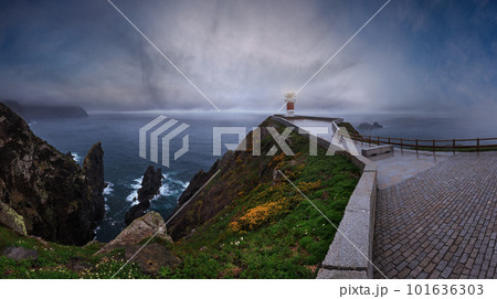 Glows Cape Ortegal Lighthouse (Province of A Coruna, Galicia, Spain). Summer rainy late evening view. Glows Cape Ortegal Lighthouse (Province of A Coruna, Galicia, Spain). Summer rainy late evening view. 101636303