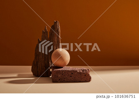 Natural stone podium and wooden ball for beauty and spa cosmetic brand display on brown background. Front view Natural stone podium and wooden ball for beauty and spa cosmetic brand display on brown background. Front view 101636751