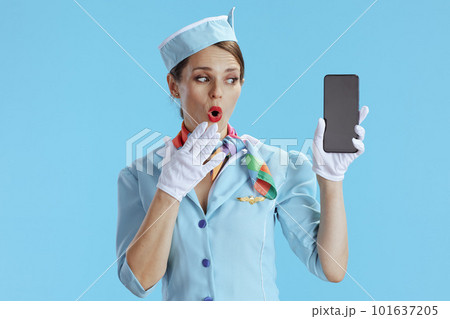 female air hostess on blue showing smartphone blank screen female air hostess on blue showing smartphone blank screen 101637205