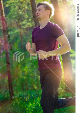 Man jogging in city partk at beautiful summer day. Sport fitness model caucasian ethnicity training outdoor. 101638863