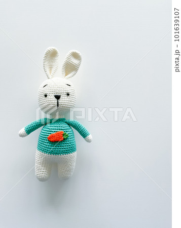Soft white crochet bunny. on a white background. Soft white crochet bunny. on a white background. 101639107