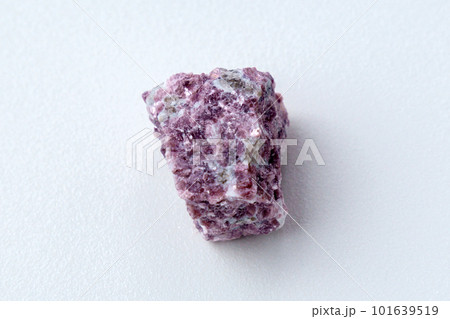 Mineral stone lepidolite. Macro shooting of natural gemstone. The raw mineral, white backround 101639519