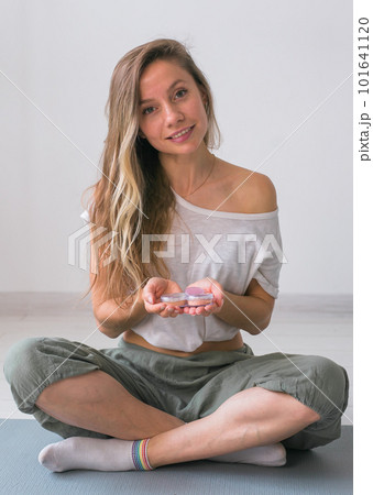 Portrait of beautiful young woman keeps makeup mineral powder for face and eyeshadows - make-up products and eco mineral natural cosmetic 101641120