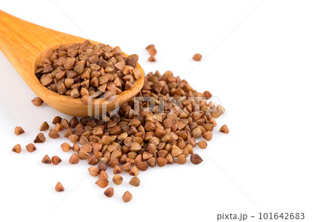 Uncooked buckwheat on wooden spoon Uncooked buckwheat on wooden spoon 101642683