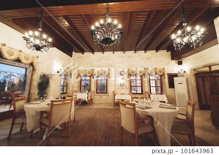 traditional spacious interior of modern empty large restaurant with tables and chairs 101643963