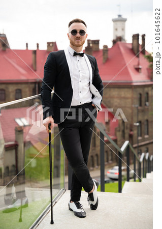 handsome fashionable guy dressed in retro style with glasses and cane handsome fashionable guy dressed in retro style with glasses and cane 101645622