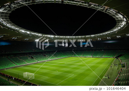 An open football stadium with empty stands with green seats. An open football stadium with empty stands with green seats. 101646404