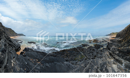 Storm on Castelejo beach with black schist stone cliffs and yelloy sand (Algarve, Portugal). Storm on Castelejo beach with black schist stone cliffs and yelloy sand (Algarve, Portugal). 101647356