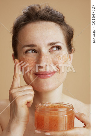 happy woman with face scrub 101647527