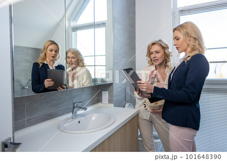 Professional realtor showing a new house to her female client Professional realtor showing a new house to her female client 101648390