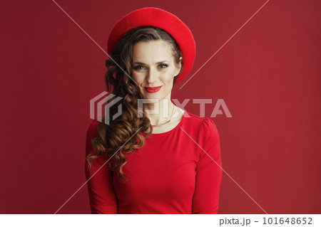 happy stylish woman in red dress and beret isolated on red happy stylish woman in red dress and beret isolated on red 101648652