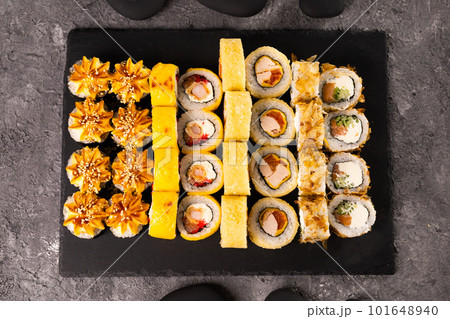 Sushi rolls set on dark background. Japanese and asian food concept 101648940