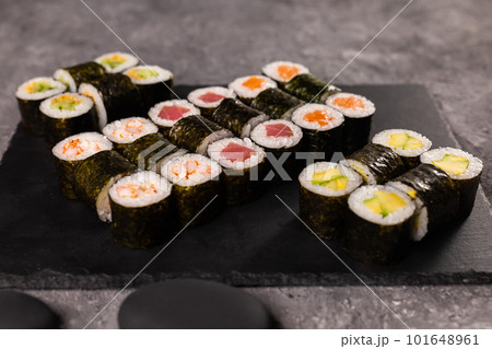 Sushi rolls set on dark background. Japanese and asian food concept Sushi rolls set on dark background. Japanese and asian food concept 101648961