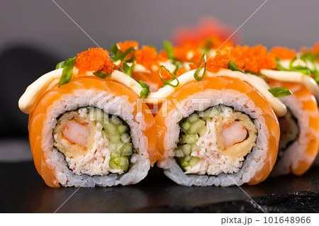 Sushi roll on dark background. Japanese and asian food concept Sushi roll on dark background. Japanese and asian food concept 101648966