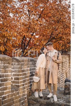 young couple kissing at the Great Wall of China. Newly married couple on their honeymoon to the Great Wall of China near Beijing China. young couple kissing at the Great Wall of China. Newly married couple on their honeymoon to the Great Wall of China near Beijing China. 101649178