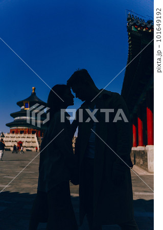 beautiful couple very much in love exploring China on their honeymoon. Couple walking through the temple of heaven, taking in all of the architecture and culture. 101649192