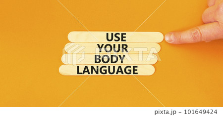 Use your body language symbol. Concept words Use your body language on wooden stick. Beautiful orange table orange background. Motivational business use your body language concept. Copy space. 101649424