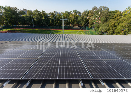 A set of solar panels mounted one next to the other on the roof of the building. A set of solar panels mounted one next to the other on the roof of the building. 101649578