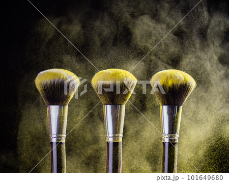 Cosmetics brush and explosion colorful makeup powder background - beauty make-up product and mineral cosmetic concept 101649680