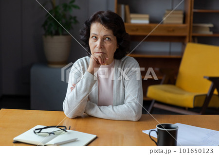 Sad tired ill sick lonely disappointed older senior woman sitting at home alone. Unhappy mature grandmother experiencing grief relative death bad news. Stressed elder lady suffering from loneliness 101650123