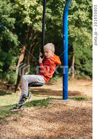 Funny cute happy baby playing on the playground. The emotion of happiness, fun, joy. Smile of a child. boy playing on the playground Funny cute happy baby playing on the playground. The emotion of happiness, fun, joy. Smile of a child. boy playing on the playground 101650803