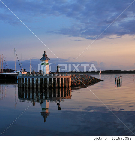 Small lighthouse and sailing boats at sunset in Ebeltoft. Small lighthouse and sailing boats at sunset in Ebeltoft. 101651088
