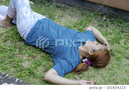 Young Asian woman fainting on grass in summer because outdoors of hot weather 101654215
