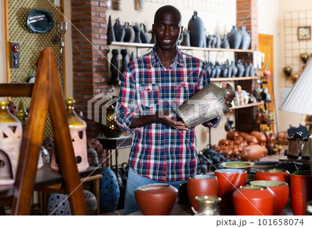 Male shop assistant in pottery shop Male shop assistant in pottery shop 101658074