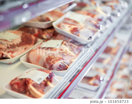 Packaged pork meat laid out on display shelves of butcher store Packaged pork meat laid out on display shelves of butcher store 101658723