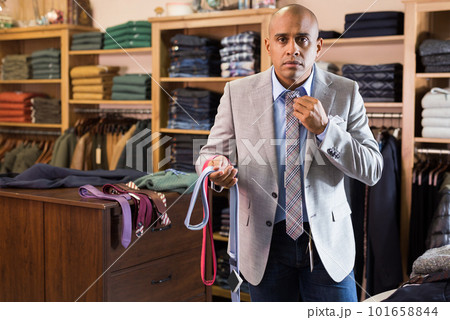 Man choosing new tie in clothing boutique 101658844