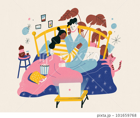Lovely couple watching movie in bed 101659768
